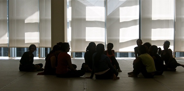 Silhouette photo of people sitting on a floor