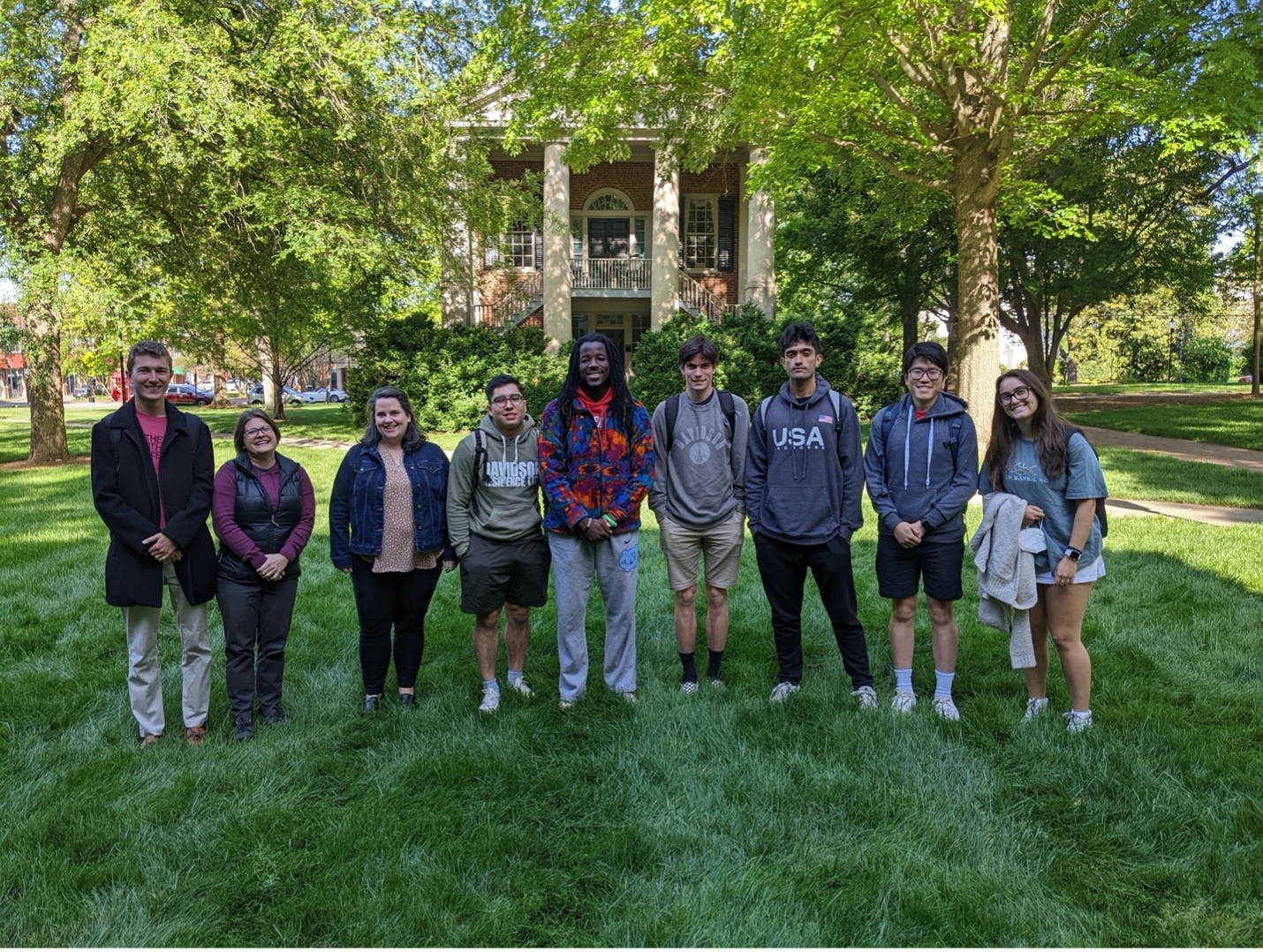 Group of students taking a picture on Davidson College lawn.