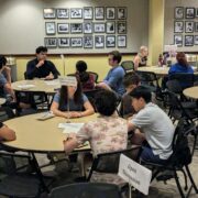 Students discussing around tables