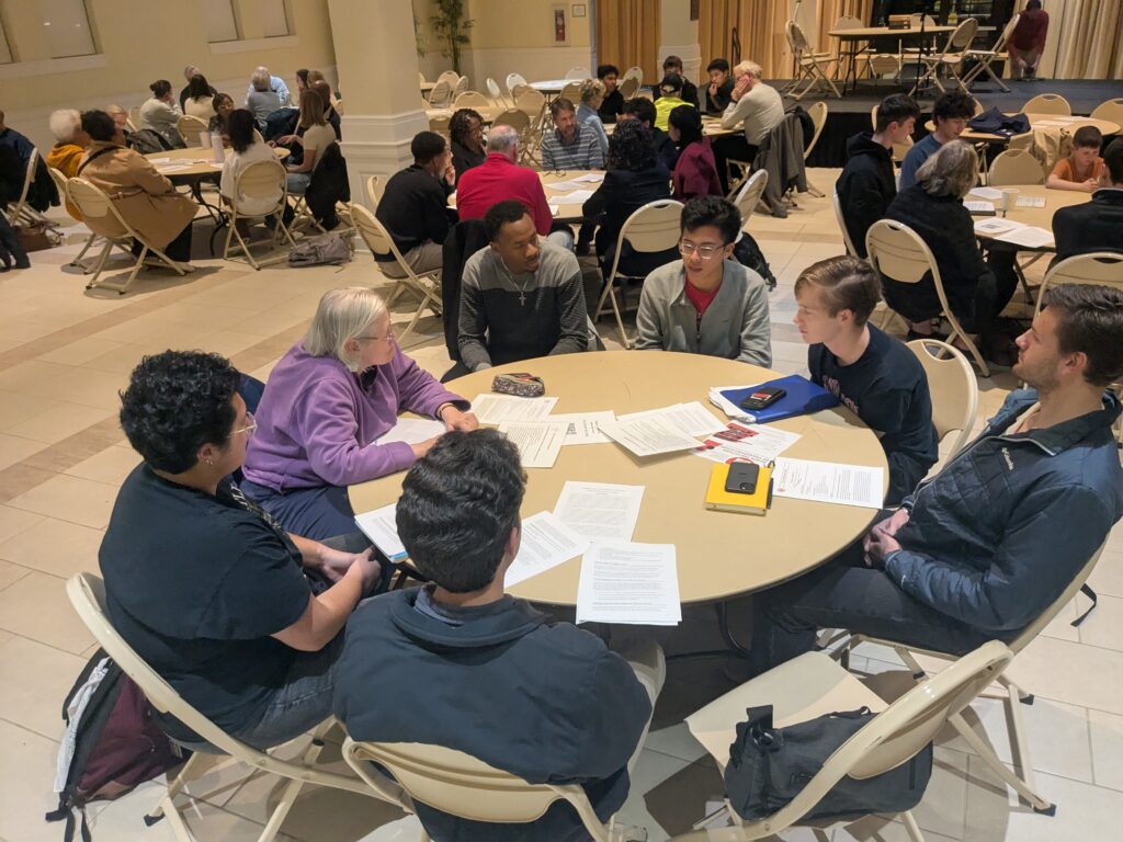 participants sitting around a table talking