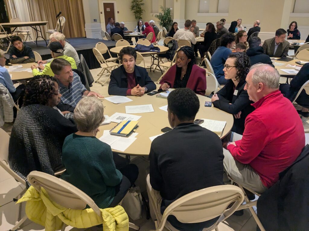 Participants sitting around a table talking