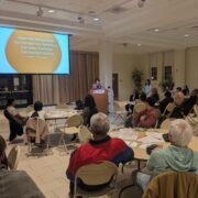 photo of deliberative event with screen in the background