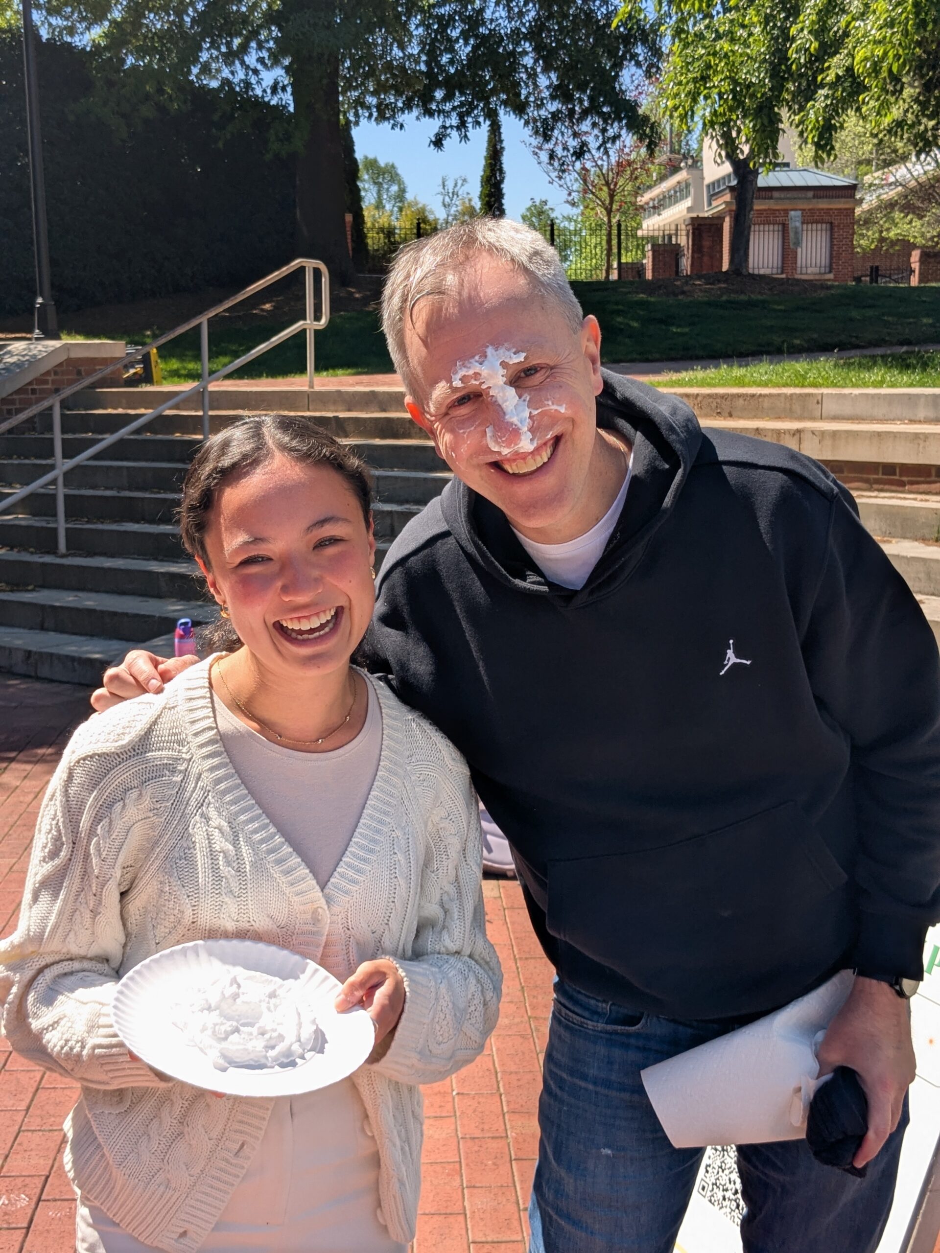 Luna and Dr. Bullock at All in for Davidson, Dr. Bullock has cream on his face.