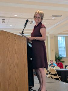 Jacquie Pffeffer Merrill at the podium.