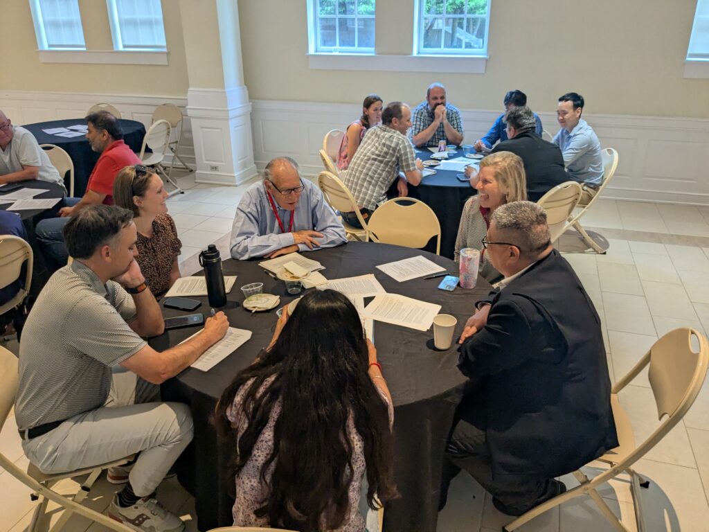 Deliberators deliberating around tables.