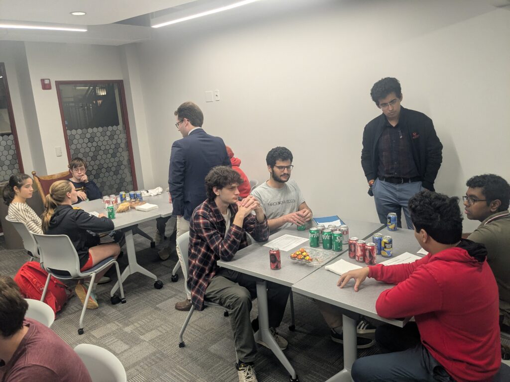 deliberators around tables with two facilitators standing