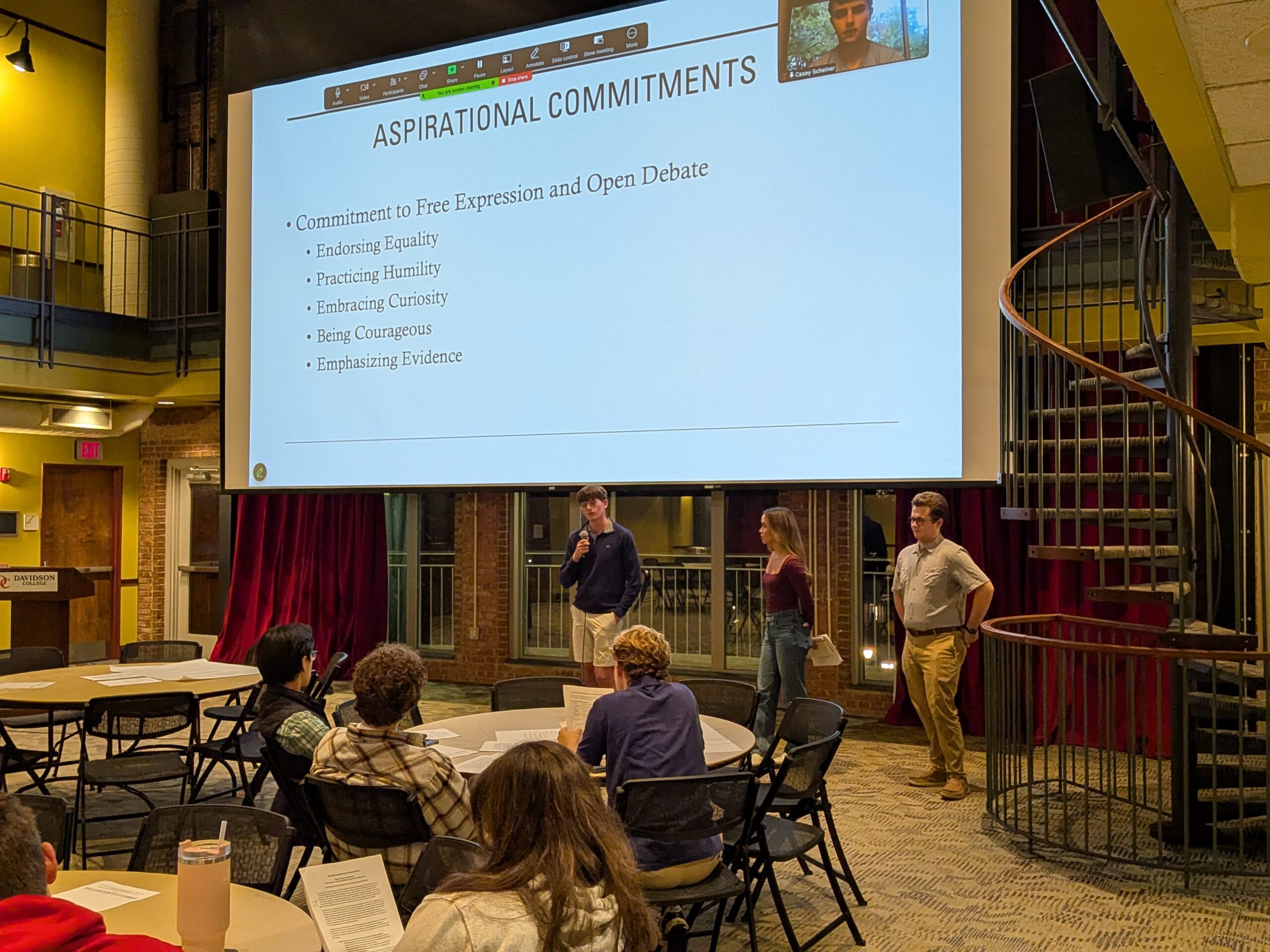 Students presenting in the 900 Room.