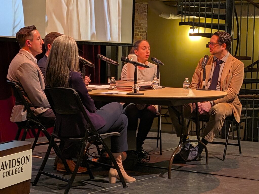 Photo of panelists talking to each other